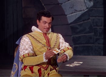 Movie still from “The Great Caruso” (1951), directed by Richard Thorpe – A man dressed as a king playing a card game; Medium shot, High angle