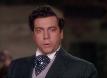 Movie still from “The Great Caruso” (1951), directed by Richard Thorpe – A person wearing a suit and a tie; Close Up shot, High angle