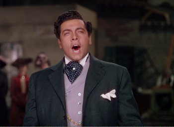 Movie still from “The Great Caruso” (1951), directed by Richard Thorpe – A person wearing a suit and tie; Close Up shot, Low angle