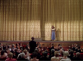 Movie still from “The Great Caruso” (1951), directed by Richard Thorpe – A woman standing on a stage in front of an audience; Extreme Wide shot, Low angle