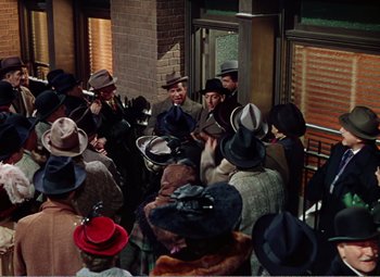 Movie still from “The Great Caruso” (1951), directed by Richard Thorpe – A group of people wearing hats standing next to each other; Wide shot, High angle