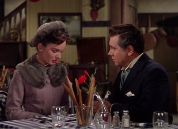 Movie still from “The Great Caruso” (1951), directed by Richard Thorpe – A man and a woman sitting at a table; Medium shot, Over the shoulder angle