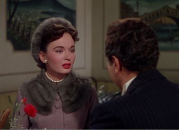 Movie still from “The Great Caruso” (1951), directed by Richard Thorpe – A woman in a fur coat and a man in a suit; Close Up shot, Over the shoulder angle