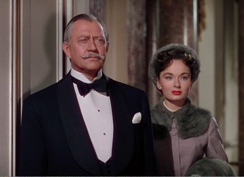 Movie still from “The Great Caruso” (1951), directed by Richard Thorpe – An older man in a tuxedo and a young woman in a fur coat; Medium shot, Low angle
