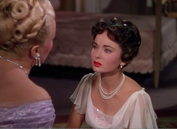 Movie still from “The Great Caruso” (1951), directed by Richard Thorpe – A woman in a white dress talking to another woman in a white dress; Close Up shot, Over the shoulder angle