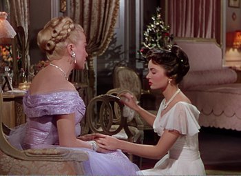 Movie still from “The Great Caruso” (1951), directed by Richard Thorpe – Two women sitting on a chair in a living room; Medium shot, Over the shoulder angle