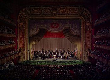 Movie still from “The Great Caruso” (1951), directed by Richard Thorpe – An orchestra performing on a stage in front of an audience; Extreme Wide shot, High angle