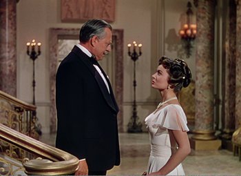 Movie still from “The Great Caruso” (1951), directed by Richard Thorpe – An older man in a tuxedo and a young woman in a white dress; Medium shot, Low angle