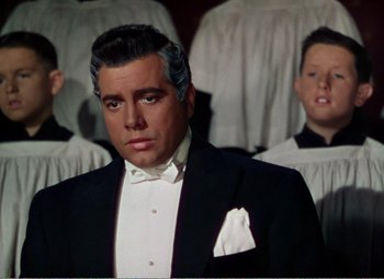 Movie still from “The Great Caruso” (1951), directed by Richard Thorpe – A person wearing a suit and tie; Close Up shot, Low angle