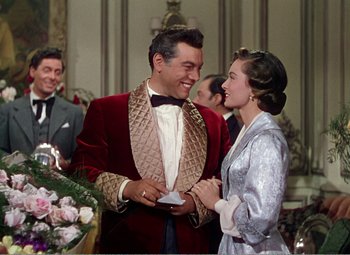 Movie still from “The Great Caruso” (1951), directed by Richard Thorpe – A man and a woman are smiling at each other; Medium shot, Over the shoulder angle