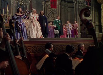 Movie still from “The Great Caruso” (1951), directed by Richard Thorpe – A group of people on a stage in costumes; Wide shot, High angle