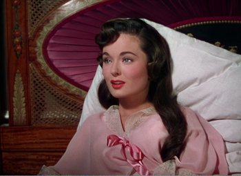 Movie still from “The Great Caruso” (1951), directed by Richard Thorpe – A beautiful woman in a pink robe sitting in a chair; Close Up shot, High angle