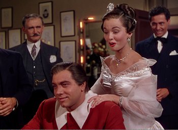 Movie still from “The Great Caruso” (1951), directed by Richard Thorpe – A man and a woman in formal wear in a room; Medium shot, Over the shoulder angle