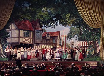 Movie still from “The Great Caruso” (1951), directed by Richard Thorpe – A painting of people on a stage in a medieval setting; Extreme Wide shot, High angle