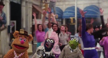 Movie still from “The Great Muppet Caper” (1981), directed by Jim Henson – A group of people standing next to each other on a street; Wide shot, Low angle