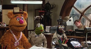 Movie still from “The Great Muppet Caper” (1981), directed by Jim Henson – A group of muppets sitting in a room; Wide shot, High angle