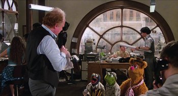 Movie still from “The Great Muppet Caper” (1981), directed by Jim Henson – A group of people sitting in front of a large window; Wide shot, Over the shoulder angle