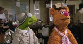 Movie still from “The Great Muppet Caper” (1981), directed by Jim Henson – A man and a woman dressed as kermit and fozzie bear; Medium shot, Over the shoulder angle