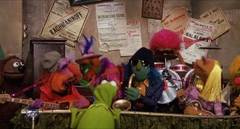 Movie still from “The Great Muppet Caper” (1981), directed by Jim Henson – A group of stuffed animals sitting next to each other on top of a table; Wide shot, High angle