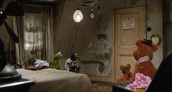 Movie still from “The Great Muppet Caper” (1981), directed by Jim Henson – A room filled with furniture and a bed with a teddy bear on the floor; Wide shot, High angle