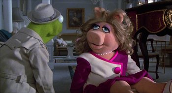 Movie still from “The Great Muppet Caper” (1981), directed by Jim Henson – A woman dressed as kermit the frog and miss piggy; Medium shot, Over the shoulder angle