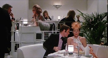 Movie still from “The Great Muppet Caper” (1981), directed by Jim Henson – A man and a woman sitting at a table in front of a mirror; Medium shot, Over the shoulder angle