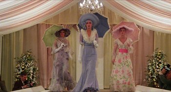 Movie still from “The Great Muppet Caper” (1981), directed by Jim Henson – A group of three women dressed up in fancy outfits; Wide shot, Low angle