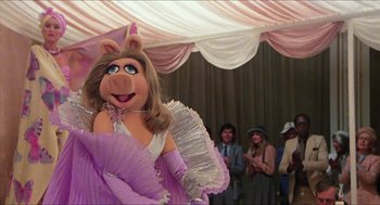 Movie still from “The Great Muppet Caper” (1981), directed by Jim Henson – A woman dressed as miss piggy at a party; Medium shot, Low angle