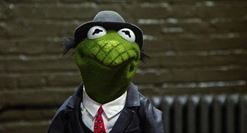 Movie still from “The Great Muppet Caper” (1981), directed by Jim Henson – A stuffed animal wearing a suit and hat; Close Up shot, Low angle