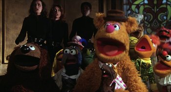 Movie still from “The Great Muppet Caper” (1981), directed by Jim Henson – A group of people standing next to each other with stuffed animals; Medium shot, Low angle