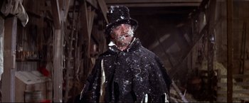 Movie still from “The Great Race” (1965), directed by Blake Edwards – A man wearing a black hat and a black cape; Medium shot, Low angle