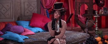 Movie still from “The Great Race” (1965), directed by Blake Edwards – A woman sitting on the ground wearing a hat and gloves; Medium shot, High angle