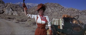 Movie still from “The Great Race” (1965), directed by Blake Edwards – A woman wearing a cowboy hat and riding gear; Medium shot, Low angle