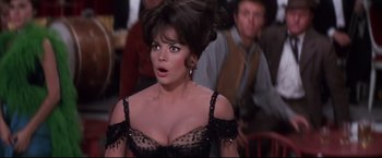 Movie still from “The Great Race” (1965), directed by Blake Edwards – A person wearing a dress; Close Up shot, Over the shoulder angle