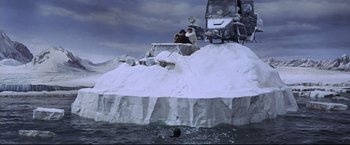 Movie still from “The Great Race” (1965), directed by Blake Edwards – Two people sitting on top of a boat in the water; Extreme Wide shot, High angle