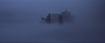 Movie still from “The Great Race” (1965), directed by Blake Edwards – A group of people standing in the fog; Extreme Wide shot, High angle
