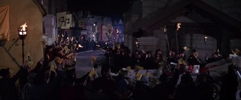 Movie still from “The Great Race” (1965), directed by Blake Edwards – A group of people are gathered around a street; Extreme Wide shot, High angle