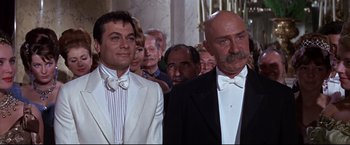 Movie still from “The Great Race” (1965), directed by Blake Edwards – Two men in tuxedos standing next to each other; Medium shot, Low angle