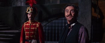 Movie still from “The Great Race” (1965), directed by Blake Edwards – A person wearing a suit and tie; Medium shot, Low angle