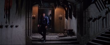 Movie still from “The Great Race” (1965), directed by Blake Edwards – A man standing in front of candles in a room; Wide shot, Low angle