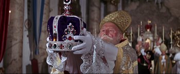 Movie still from “The Great Race” (1965), directed by Blake Edwards – An old man holding a crown in his hand; Close Up shot, Low angle