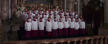 Movie still from “The Great Race” (1965), directed by Blake Edwards – A group of young men standing next to each other in choir robes; Wide shot, High angle