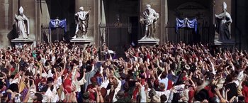 Movie still from “The Great Race” (1965), directed by Blake Edwards – A crowd of people standing in front of a building; Extreme Wide shot, High angle