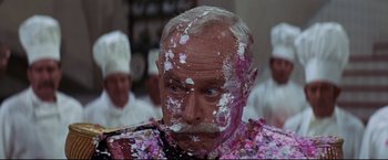 Movie still from “The Great Race” (1965), directed by Blake Edwards – An old man with a mustache covered in powdered sugar; Close Up shot, Over the shoulder angle