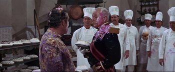 Movie still from “The Great Race” (1965), directed by Blake Edwards – A group of men standing in a kitchen; Medium shot, Over the shoulder angle