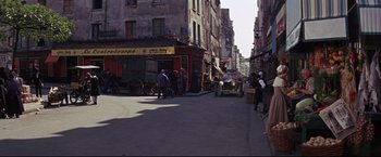 Movie still from “The Great Race” (1965), directed by Blake Edwards – An old car is parked on the side of the street; Extreme Wide shot, High angle