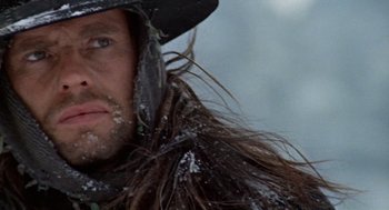 Movie still from “The Great Silence” (1968), directed by Sergio Corbucci – A man with long hair and a hat; Close Up shot, Low angle