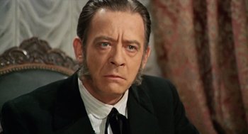 Movie still from “The Great Silence” (1968), directed by Sergio Corbucci – A person wearing a suit and tie; Close Up shot, Low angle