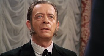 Movie still from “The Great Silence” (1968), directed by Sergio Corbucci – A person wearing a suit and a tie; Close Up shot, Over the shoulder angle