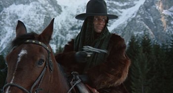 Movie still from “The Great Silence” (1968), directed by Sergio Corbucci – A person on a horse with a hat on; Medium shot, Low angle